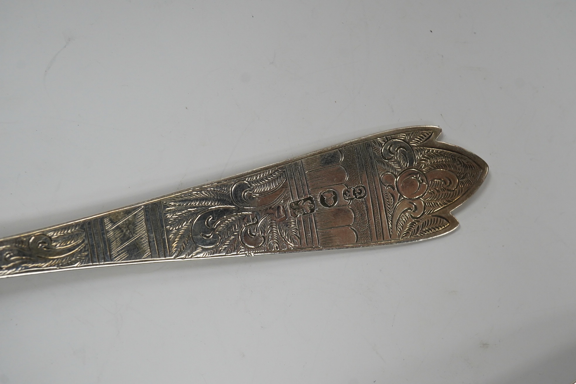 Five assorted George III and later serving spoons with later engraved decoration, earliest London, 1791, 16.8cm, 6.4oz. Condition - fair